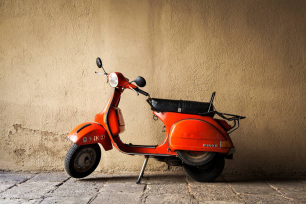 Barcelona, Spain - June 9, 2011:  Red vintage Vespa motor scooter parked by the wall