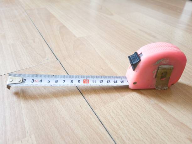 istock Modern Tape Measure Tool on a Wooden Background 1391886536
