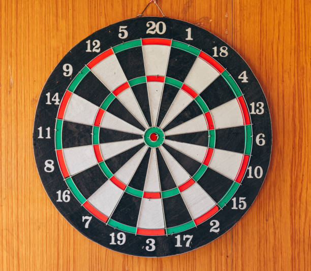 istock a dart disc in front of a wooden wall 1391887460