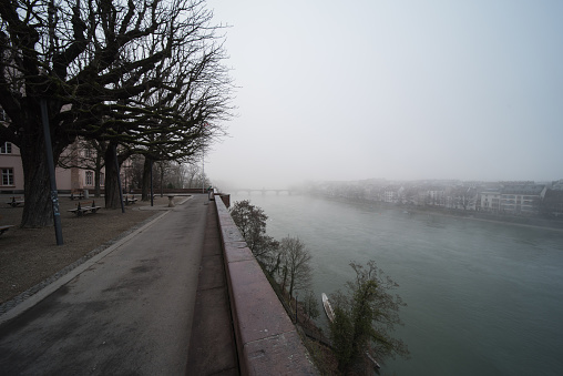 cityscape from basel in switzerland with the rhine river on a foggy day.