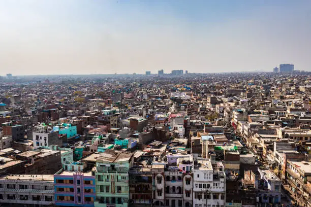 Photo of crowded city construction with flat hazy sky at morning from unique angle