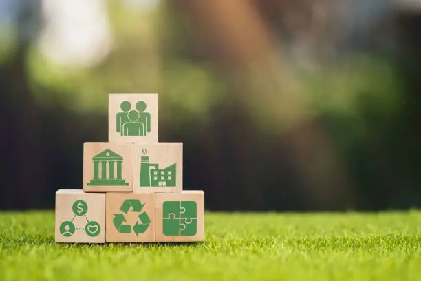 Photo of Wooden cube block with ESG icon with copy space, social and corporate governance concept. ESG modernization development by using the technology of renewable resources to reduce pollution and carbon emission.