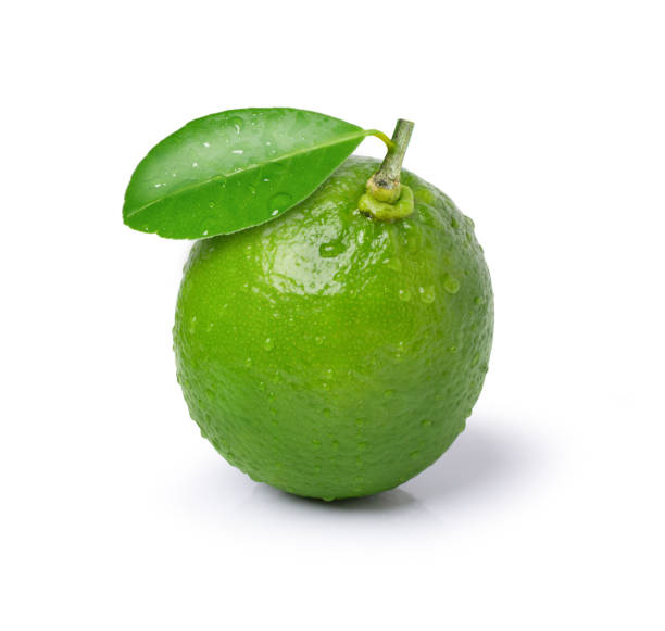 istock Lime with water droplets and green leaf 1391892876