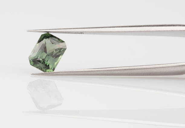 istock Green Sapphire Gemstone in Tweezers 1391895627