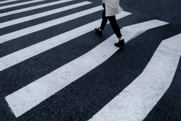 istock A woman walks across a crosswalk line 1391896938