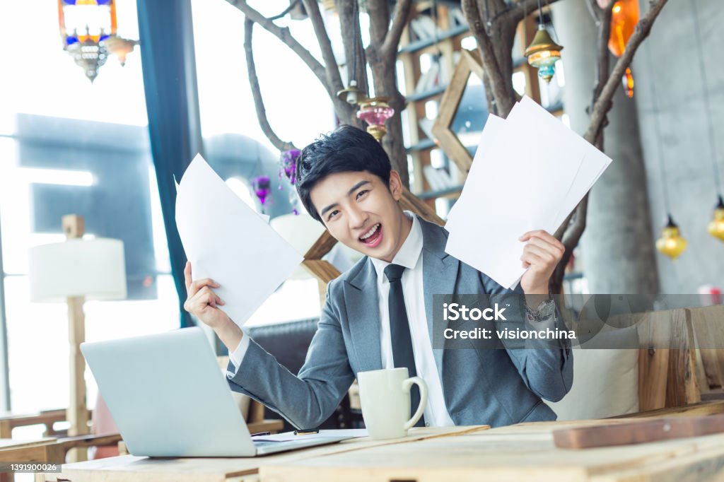 in the cafe chinese businessman handsome handsome chinese businessman drinking coffee in a cafe office Report - Document Stock Photo