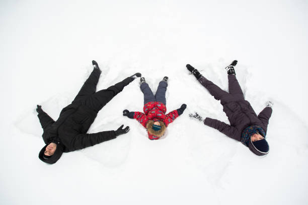 istock A young family with a child walking through a snow-covered forest. 1391900377