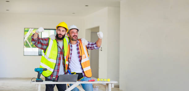 istock handshake. Electrician and construction engineer man team in safety uniform working and  planing in construction site. 1391903164