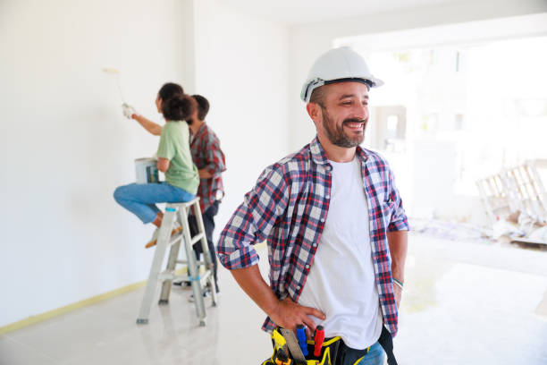 istock Portrait happy hispanic electrician man worker with professional builder team on construction site. Maintenance service Repair and handyman concept 1391903328