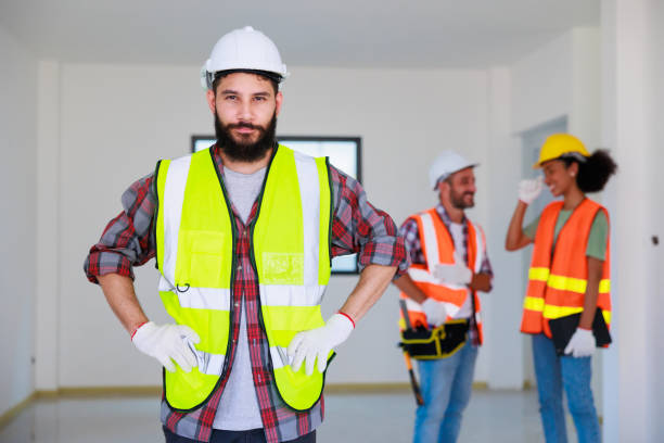 istock Portrait happy hispanic electrician man worker with professional builder team on construction site. Maintenance service Repair and handyman concept 1391903338