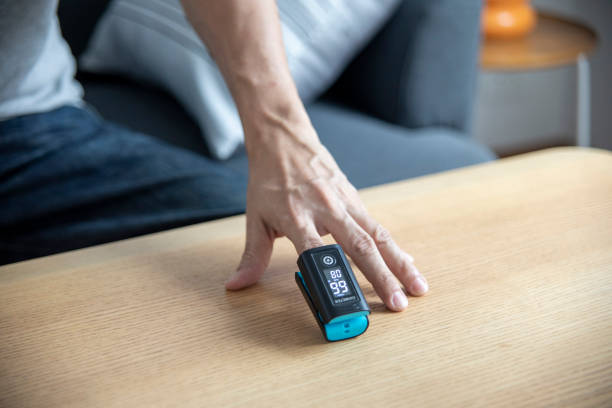 istock Man checking blood oxygen level with pulse oximeter at home. 1391905827