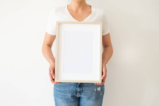 istock A wooden frame with empty space in women's hands 1391906758