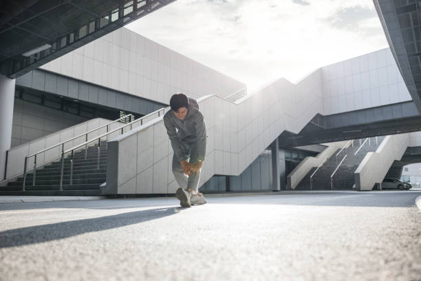 istock Young man preparing for exercise in urban scene 1391907169