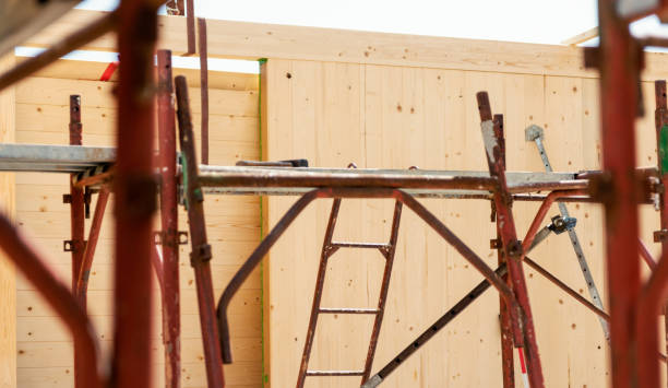 istock Rusty iron scaffolding with ladder and wooden wall 1391908555