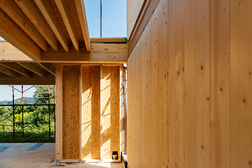 Close-up of wooden construction in interior of sustainable structure. Construction site, building modern family house.