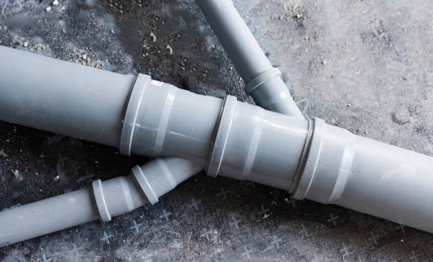 Drain piping, grey plastic pipes various diameters connecting into one stock photo