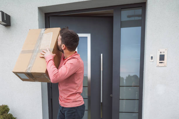 istock Overjoyed man kissing a package, standing at the front door 1391909182