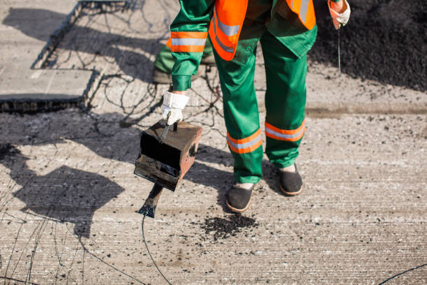 istock The man working asphalt pouring tar for road repair. 1391909500