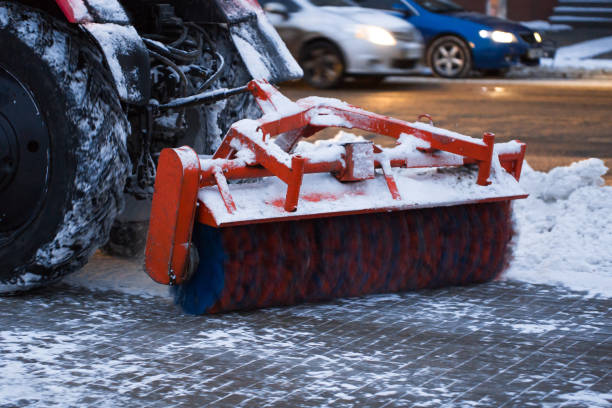 istock Tractor brushes snow on the road in the evening. 1391910079