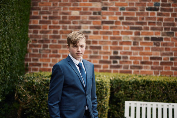 Lutheran Protestant communion. Portrait of teenager in his confirmation suit. fourteen year old boy looking at camera