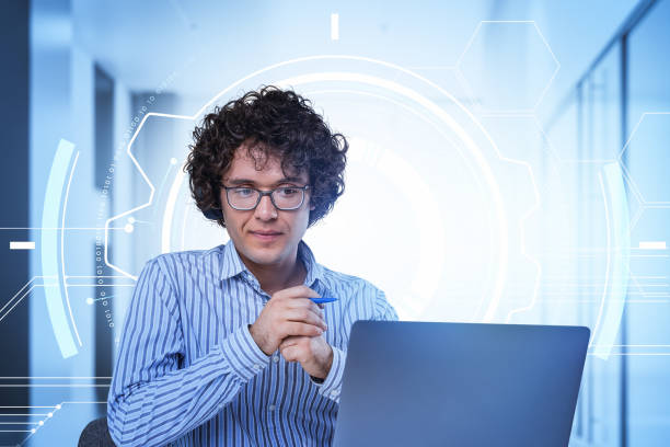istock Man working with laptop with pen in hand, office room and binary 1391911410