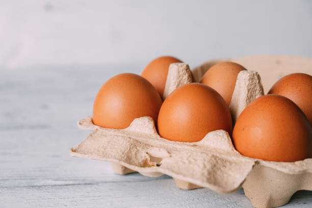 istock Cardboard egg storage box with brown chicken eggs close-up. 1391912181