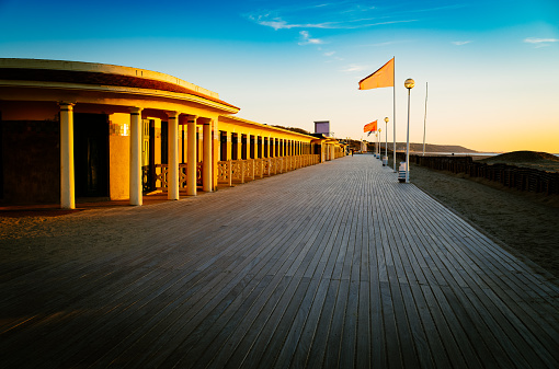 The famous boardwalk, of wooden planks running alongside the cabins with the names of film actors and directors, at Deauville on the Normandy coast of France.