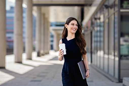 Young businesswoman is walking to her office