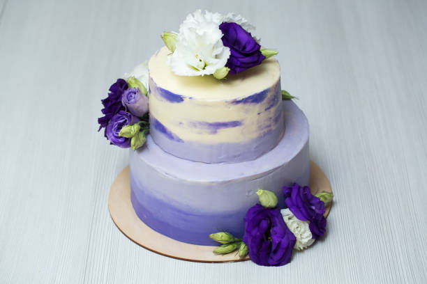 istock Wedding two-tiered purple cake with fresh flowers 1391912827