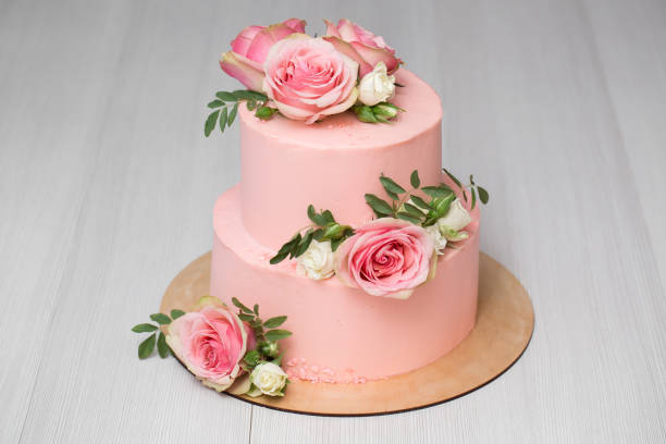 istock Delicate pink wedding cake with fresh flowers 1391912831