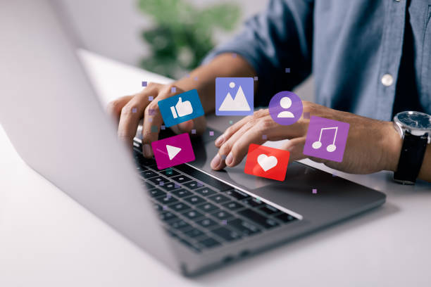 istock Content manager concept. Man works on laptop, publishes according to plan video, audio and images in social networks. 1391915053