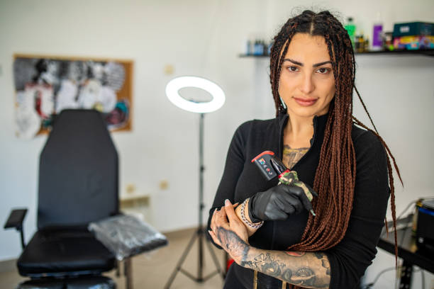 Young beautiful female tattoo artist posing in her studio