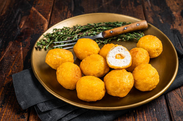 istock Fried crispy round chicken nuggets with Cheese. Wooden background. Top view 1391918062