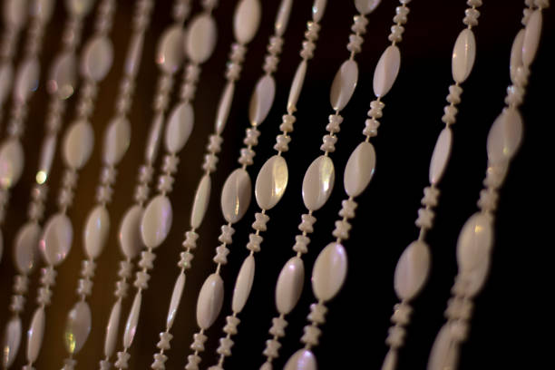 Pearl curtains on the door. Beautiful background in the old style. Detail of the interior of the 20th century. A lot of beads on the threads.