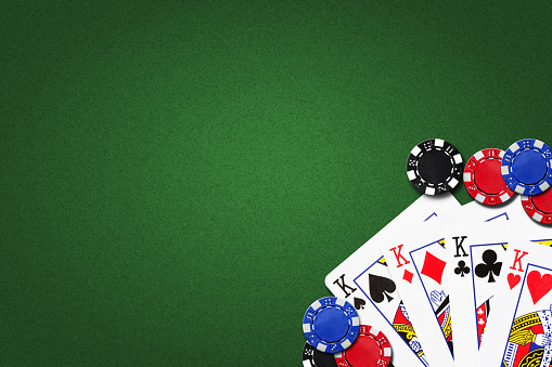 Four kings, and poker chips, on a green background. copy space. gambling.