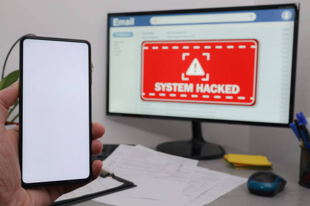 istock Hand holding mobile phone with white screen for copy space. System hacked alert after cyber attack on computer network.  Business computer hacked. 1391924566