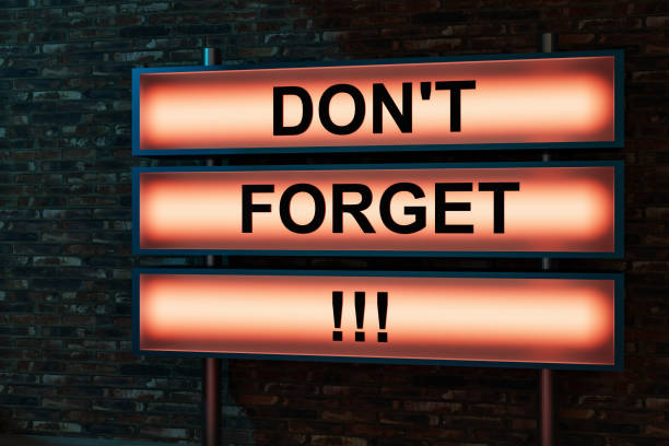istock Don't forget. Black letters on a light box. The illuminated sign placed in front of a red brick wall. 1391925824