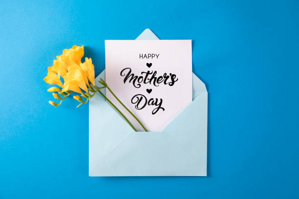 istock Yellow Flowers with White Greeting Card in Blue Envelope 1391927380