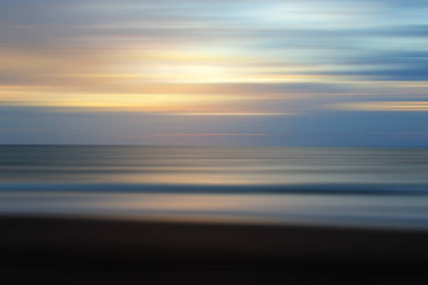 istock Natural blue background with the sunset light and smooth wave motion on the beach. 1391927454