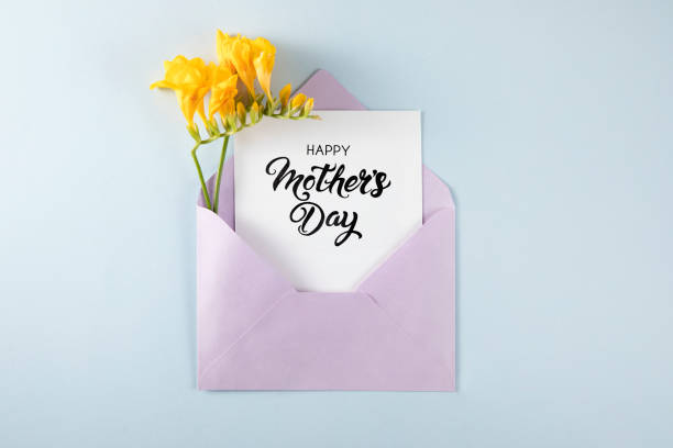 istock Yellow Flowers with White Greeting Card in Purple Envelope 1391927484