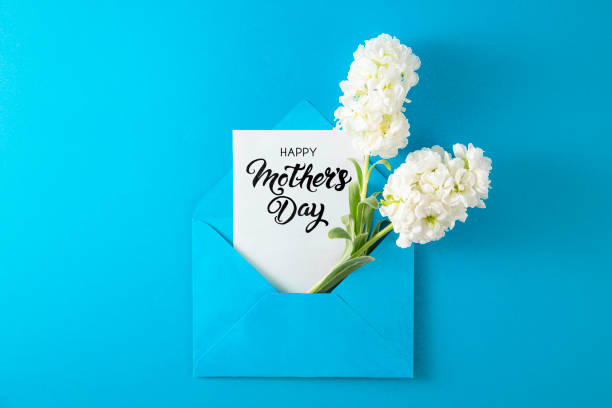 istock White Flowers with White Greeting Card in Blue Envelope 1391928021