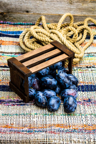 ripe plums on a counter at the market