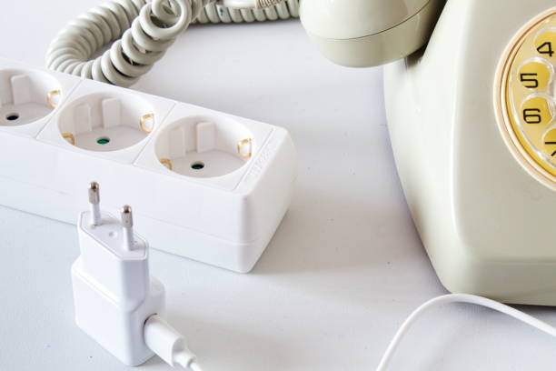 istock Old technology telephone connected to the electrical network through a plug 1391931177