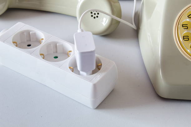 istock Old technology telephone connected to the electrical network through a plug 1391931182