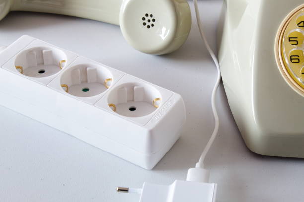 istock Old technology telephone connected to the electrical network through a plug 1391931214
