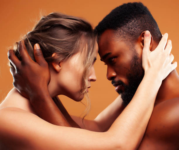 istock Young pretty couple diverse races together posing sensitive on brown background, lifestyle people concept 1391931380