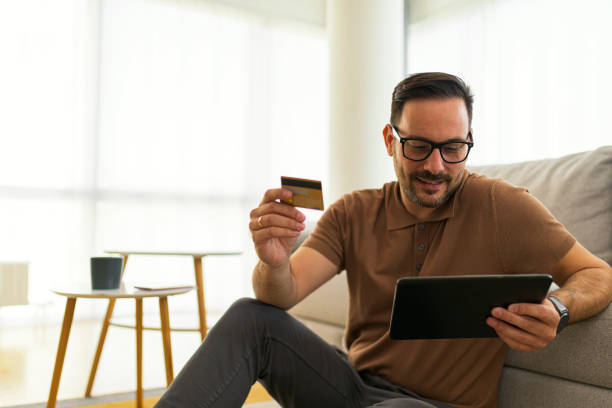 istock making online purchase holding credit card holding tablet 1391932258