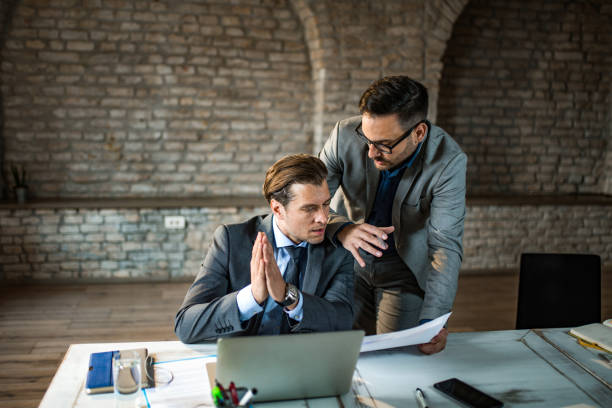 istock Two businessmen working together in office. 1391933229
