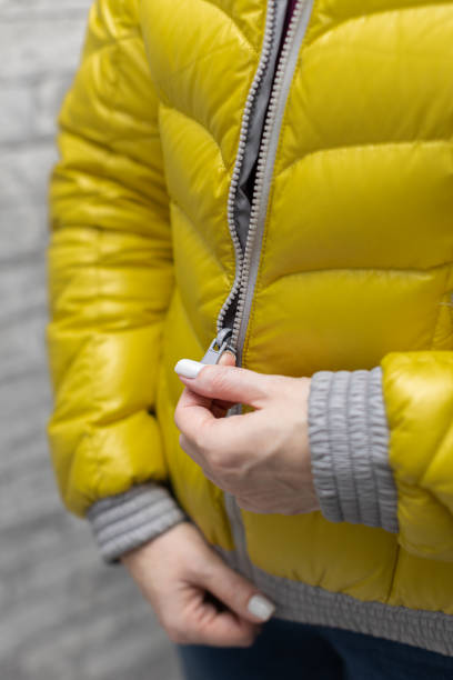 istock woman zips up her warm colored jacket 1391933575