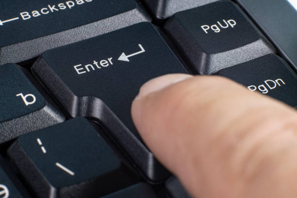 istock Enter key on a computer keyboard, a person presses a finger, close-up, selective focus 1391935020